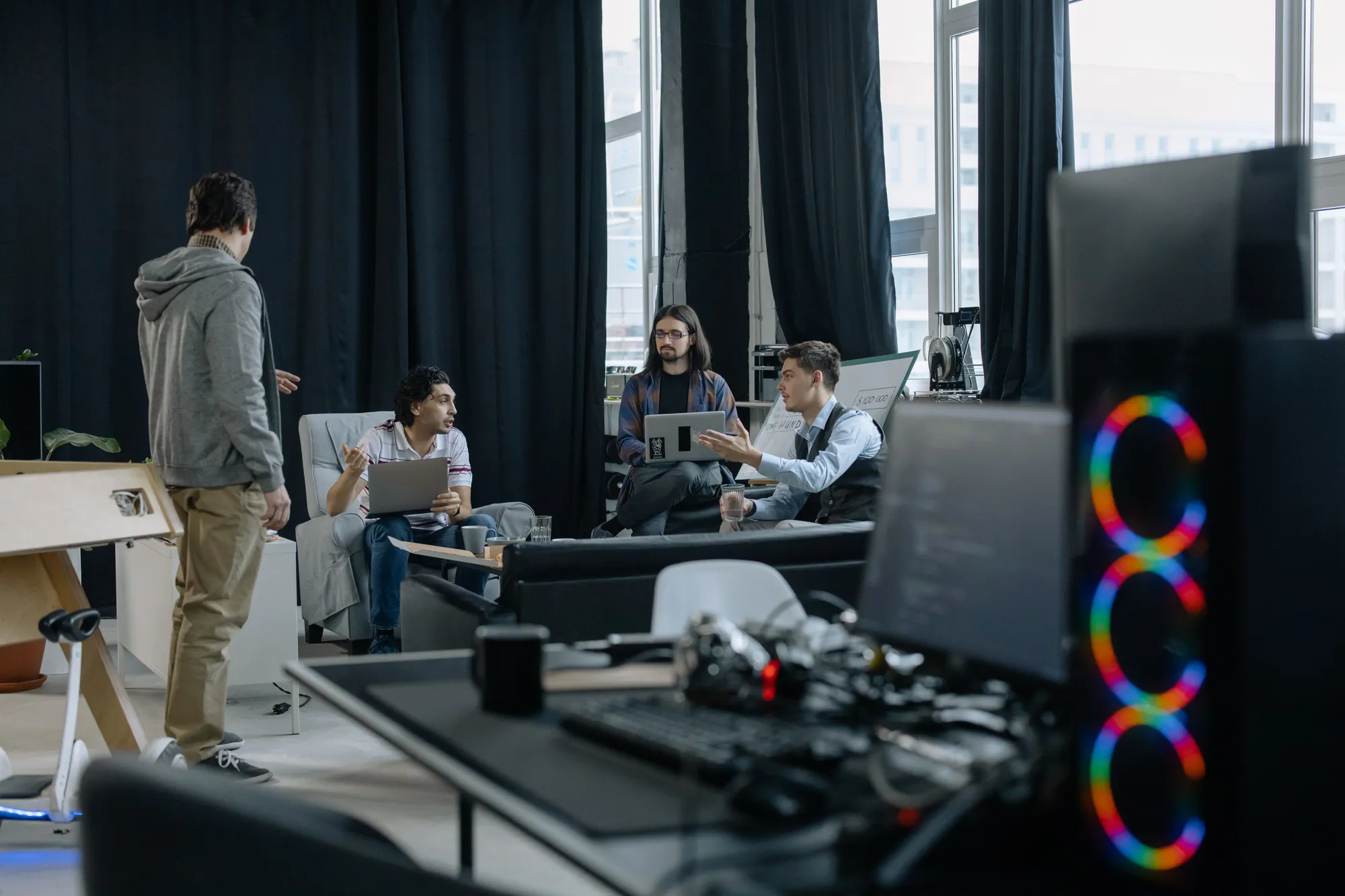 A technology team discussing a project in a modern office.